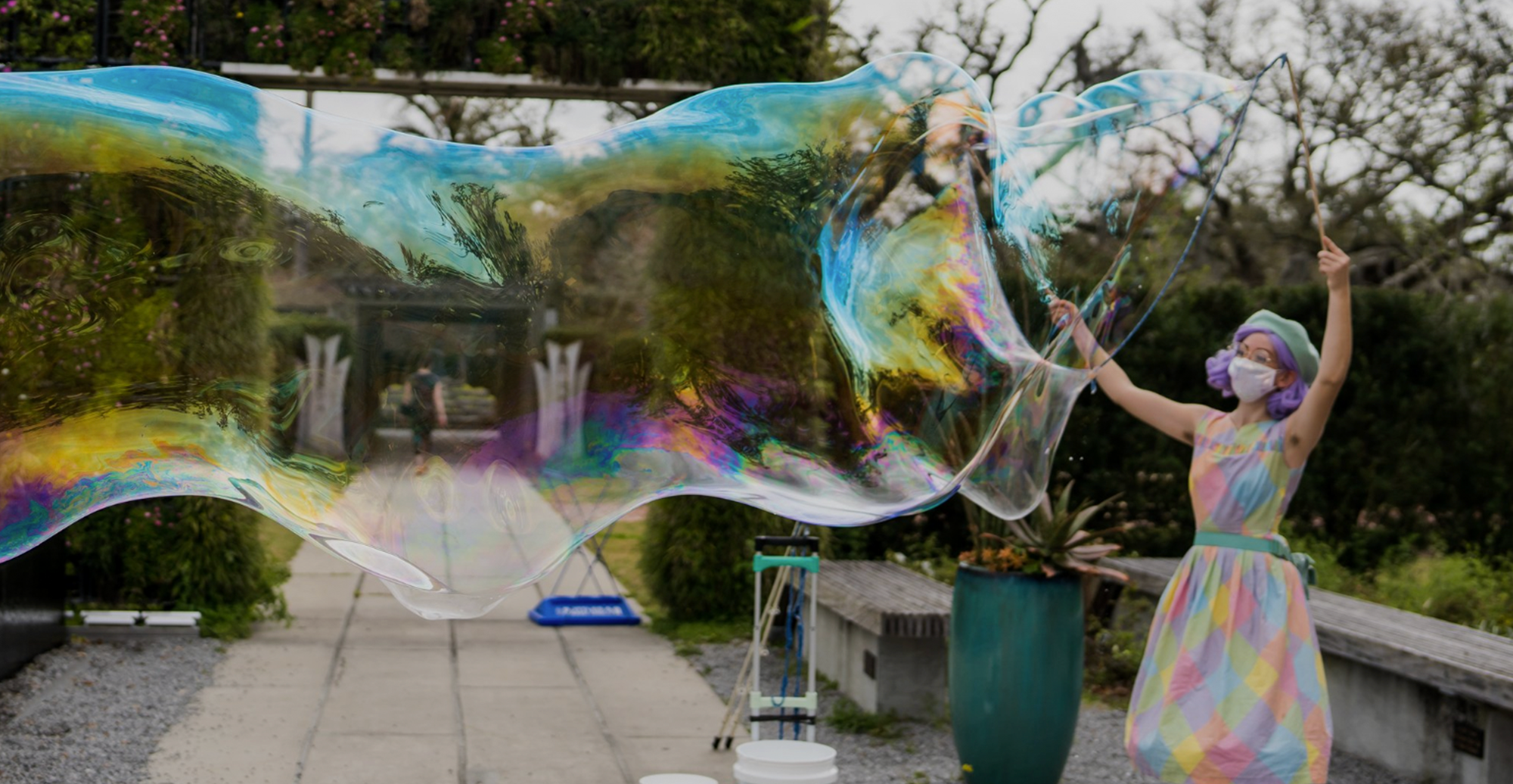 Bubble Lady Linda demonstrates her large colorful bubbles that take up an entire photo frame  